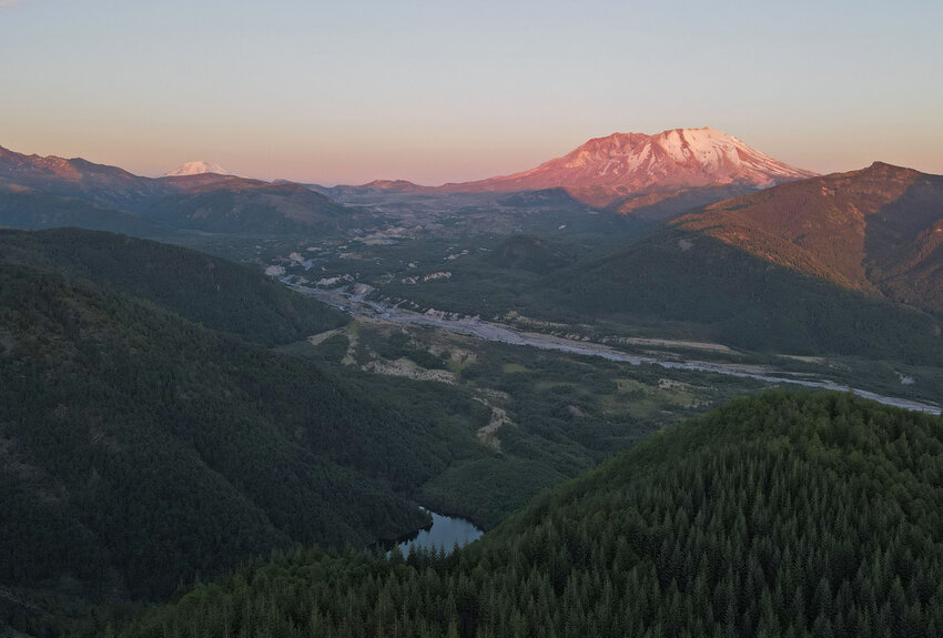 The sun sets on Mount Adams and Mount St. Helens on Wednesday, June 12.