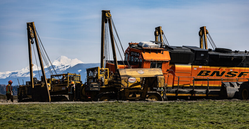 The first of two derailed BNSF engines are put back upright, with Mount Baker in the background, on the Swinomish Reservation in Anacortes, Thursday, March, 16, 2023.