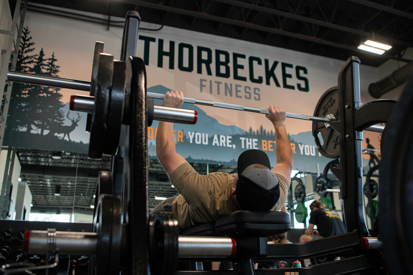 Logan Brewer bench presses at the new Thorbeckes Fitness Center in Grand Mound as it opened its doors to the public for the first time on Monday, June 17.