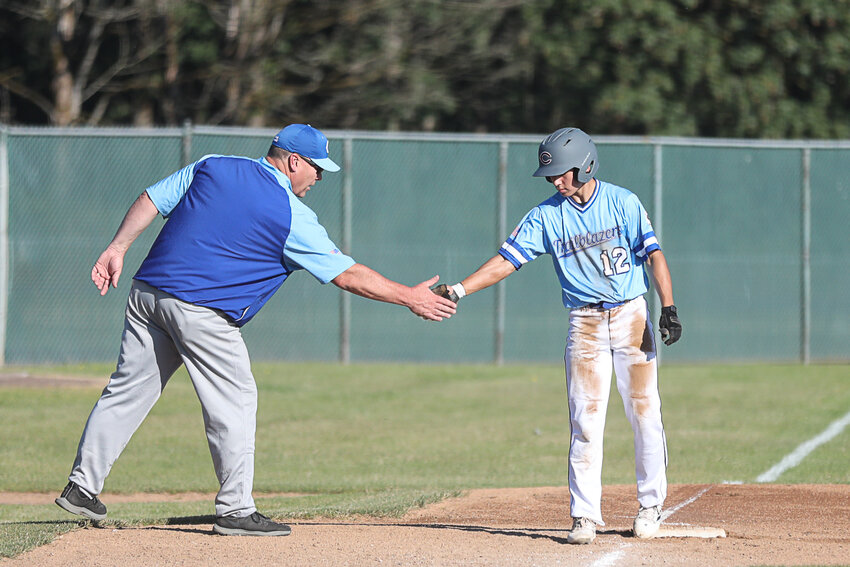 Awesome Cherovlet's Hiroto Smaciarz high-fives coach Chris McCallum after hitting a triple during the Trailblazers' win over Centralia at Wheeler Field on June 20.
