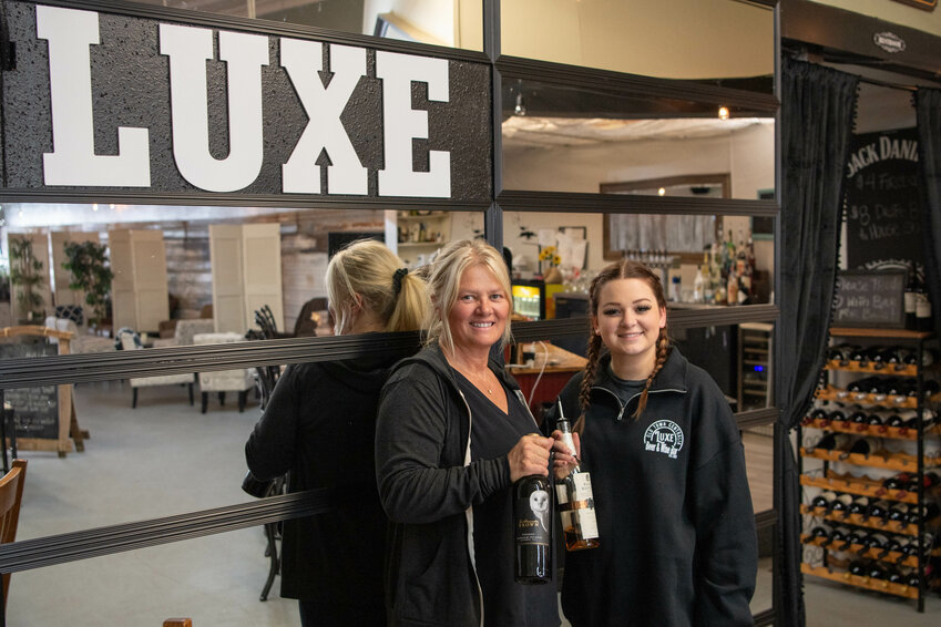 Bar owner Shawna Viggers Sicilia, left, and daughter Kai smile for a photo at Luxe Wine &amp; Whiskey in downtown Centralia on Wednesday, June 19.
