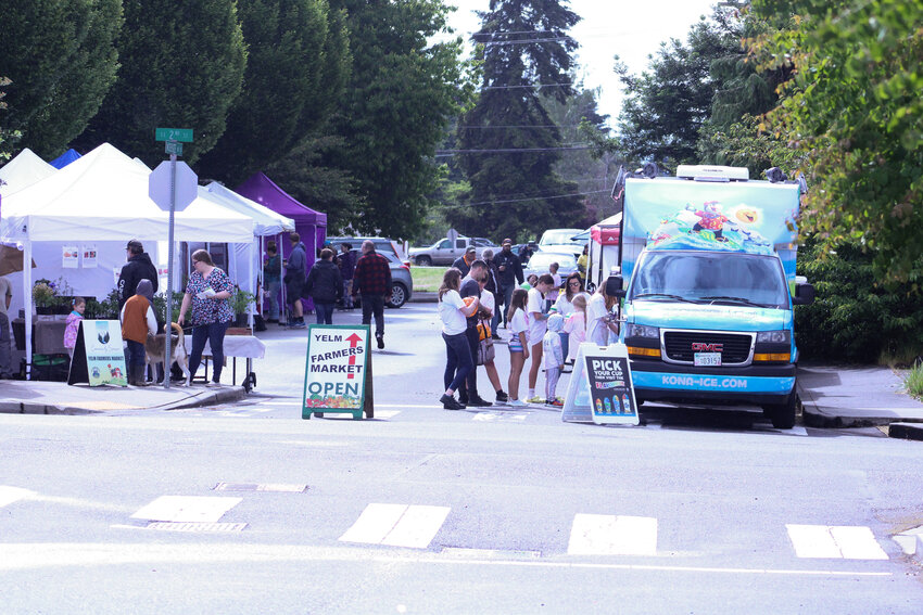 Visitors explore the Yelm Farmers Market on June 15.
