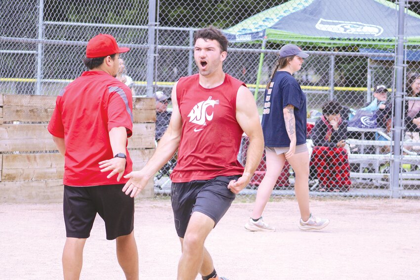 Braden Castleberry-Taylor celebrates after scoring a run during the semifinal round of the Prairie Days Charity Mushball Tournament at Longmire Park on June 23.