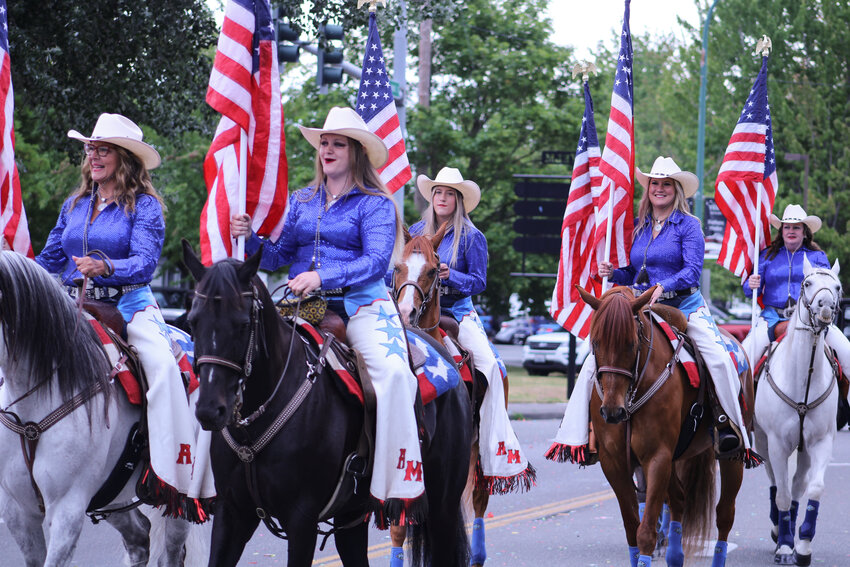 A drill team rides horses down Yelm Avenue during the Prairie Days Parade on June 22.