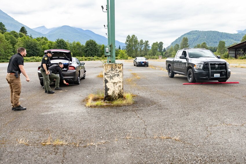 Officers practice spike strip deployment during emergency vehicle operator course (EVOC) training in Packwood on Wednesday, June 26. Washington state law requires any officer engaging in a pursuit to have completed an EVOC within the last two years and to be certified in at least one pursuit intervention option.