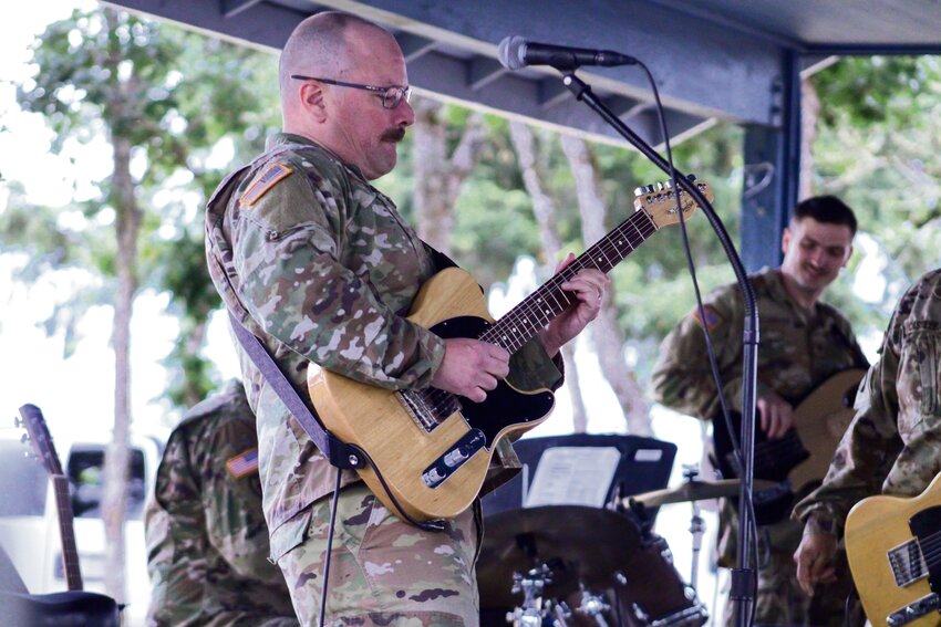 Sgt. Glenn DeVage rips a guitar solo during a performance with Full Metal Racket at the All-American Jubilee in Rainier on June 30.