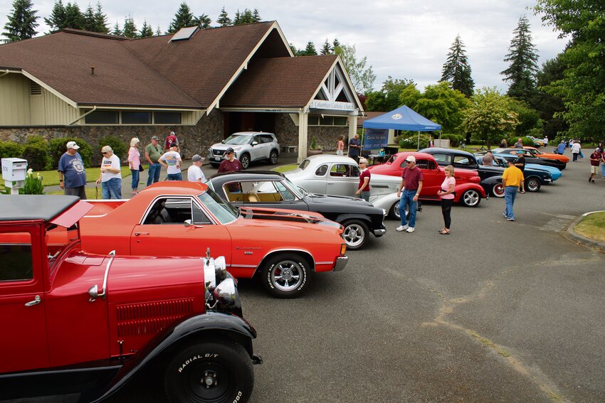 Attendees of the sixth annual Coats for Kids Car Show explore the top 10 cars, as voted on by visitors, on June 29.