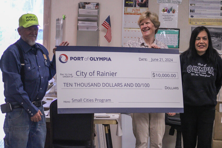 The Port of Olympia presents a $10,000 Small Cities Program grant check to the City of Rainier during a South Thurston Economic Development Initiative meeting at the Rainier Senior Center on June 21.