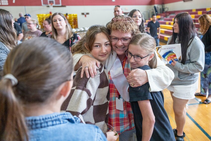 Retiring teacher Lisa Collins hugs students during an end of the year celebration in the Winlock Middle and High School gym on Friday, June 28.