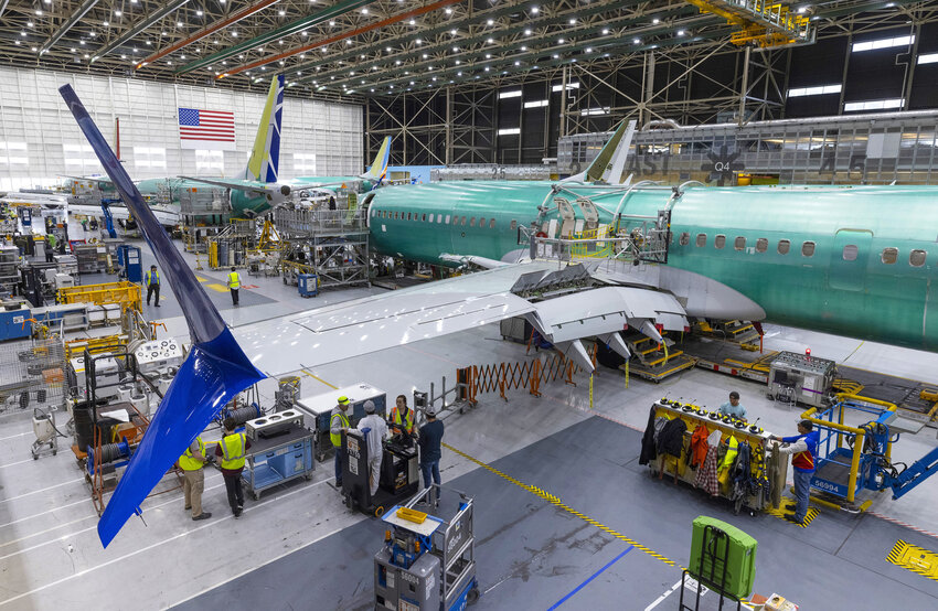 Boeing employees work on the 737 MAX on the final assembly line at Boeing&rsquo;s Renton plant Wednesday, June 15, 2022.