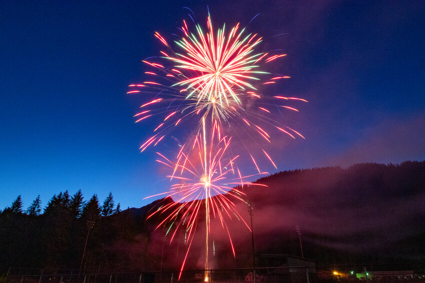 Smoke in the sky glows red as fireworks explode on Wednesday, July 3, during the Randle Firefighters Association's Big Bottom Blast fireworks show at the White Pass Jr./Sr. High School in Randle.