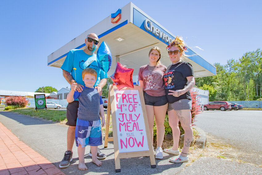 From the right, Leah Rader and her daugher Layla stand along side Leah's husband, Brad, and their son Cameron during a free Independence Day meal giveaway Leah organized at the Tower Avenue Chevron she manages on Thursday, July 4.