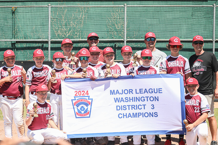 Chehalis poses with the championship banner after a 7-5 win over Larch Mountain in the District 3 Majors All-Star Tournament Championship at Fort Borst Park in Centralia on July 7.