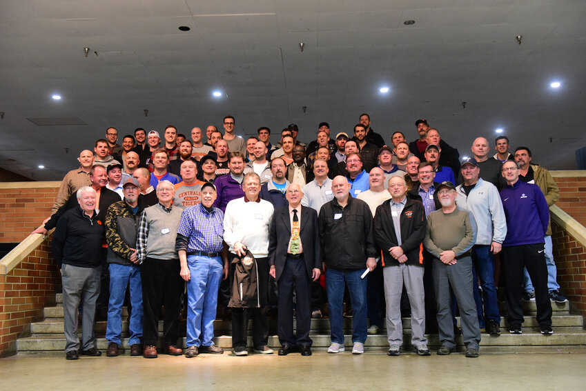 Longtime Centralia High School basketball coach Ron Brown, front and center, poses with former players at his retirement ceremony in the high school commons after a boys basketball game on Saturday, Jan. 6, 2018.