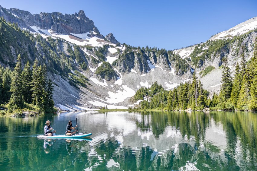 People paddle board in Snow Lake at Mount Rainier National Park on Monday, July 8.