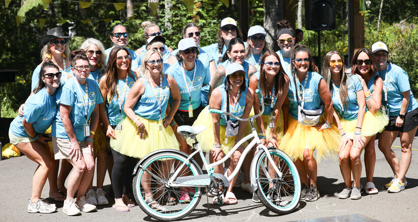 Volunteers and organizers of the Sally Strong Summer Event pose for a photo on Saturday at Summit Lake Park in Olympia.