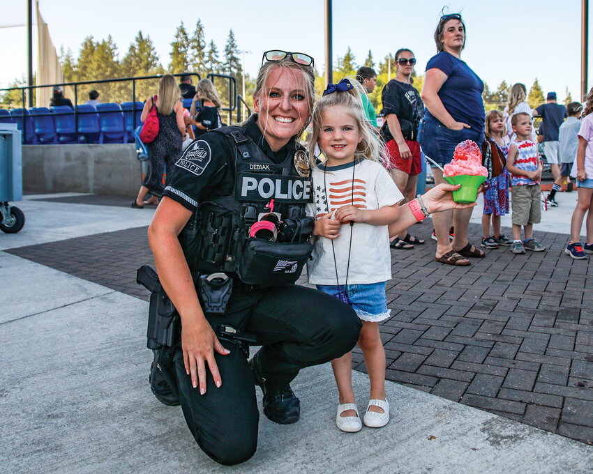 Ridgefield police officer Kaylin Debiak and her daughter enjoyed Ridgefield Raptors&rsquo; first responder night with a snow cone during the baseball game on Wednesday, July 10.