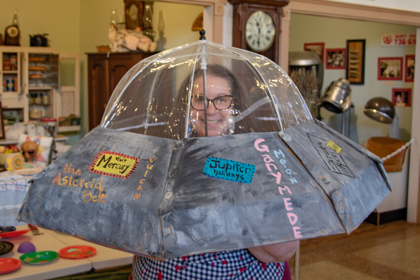 Local author Sara Light-Waller models her flying saucer costume she made on Saturday, July 13, at the Lewis County Historical Museum in preparation for the upcoming Chehalis Flying Saucer Party &quot;Alien Invasion&quot; parade on Sept. 14.