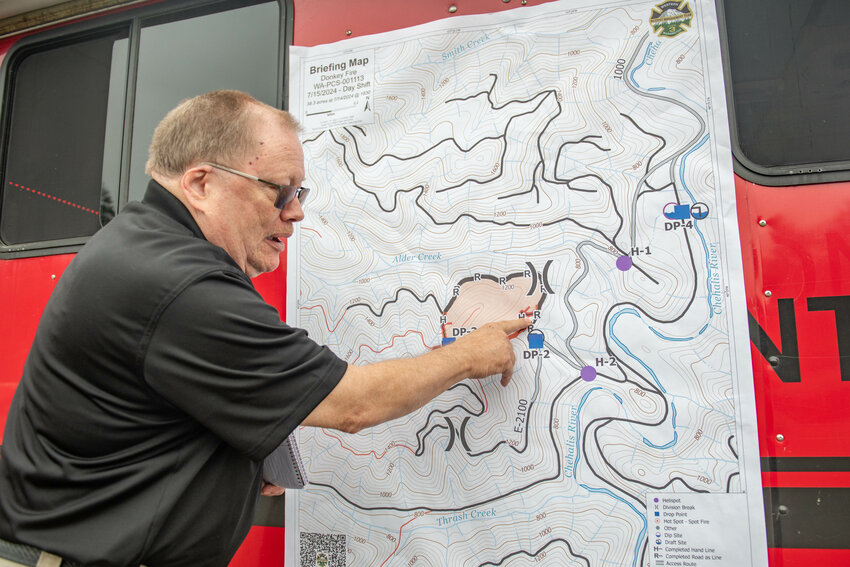 Tim McKern of the Western Washington Type 3 Incident Management Team explains the containment situation of the Donkey Fire, burning 7 or 8 miles southwest of Pe Ell, from the incident command post at the Pe Ell School on Monday, July 15.