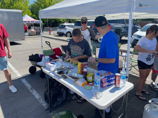 Brendan Coulliette prepares his burger at the 2023 Nisqually Valley Barbecue Rally.