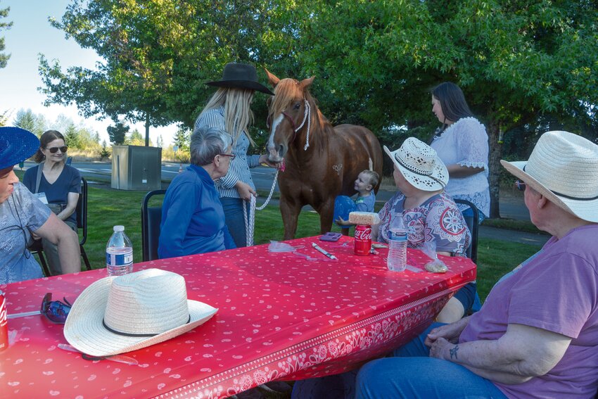 A member of the Washington State High School Rodeo Association introduces a horse to attendees at the Rosemont Round-Up in 2023.