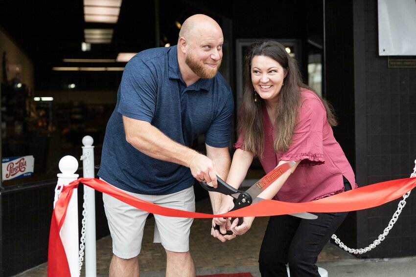 Frank and Danielle Pfannes smile during a ribbon-cutting ceremony for the Northwest Salmon Smokehouse and Artisan Market in Chehalis on Thursday, July 18.