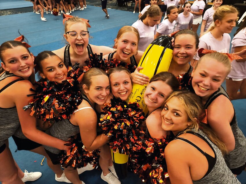 Rainier High School cheerleaders pose for a photo with the UCA spirit banana during the UCA camp at Great Wolf Lodge.