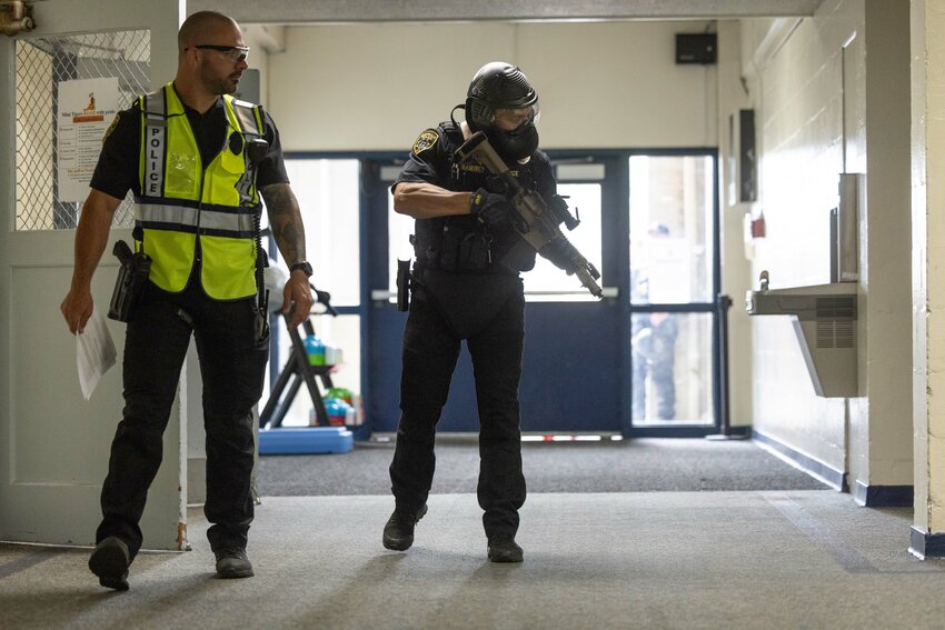 Officer Ruben Ramirez, right, scopes out the scene during active shooter training at Washington Elementary School on Wednesday, July 24. Officer Kyle Stockdale, left, followed officers during training to provide feedback.