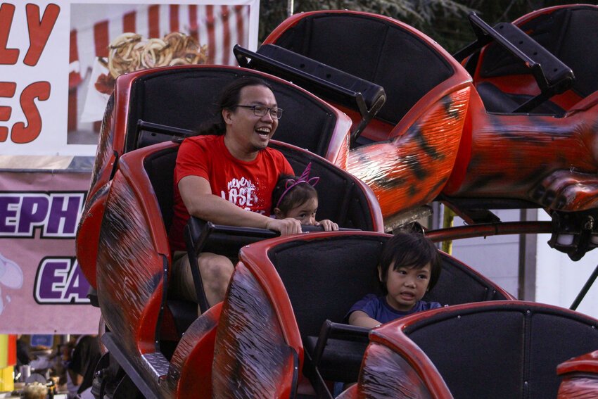 Fairgoers ride a roller coaster during the Thurston County Fair on Aug. 3.