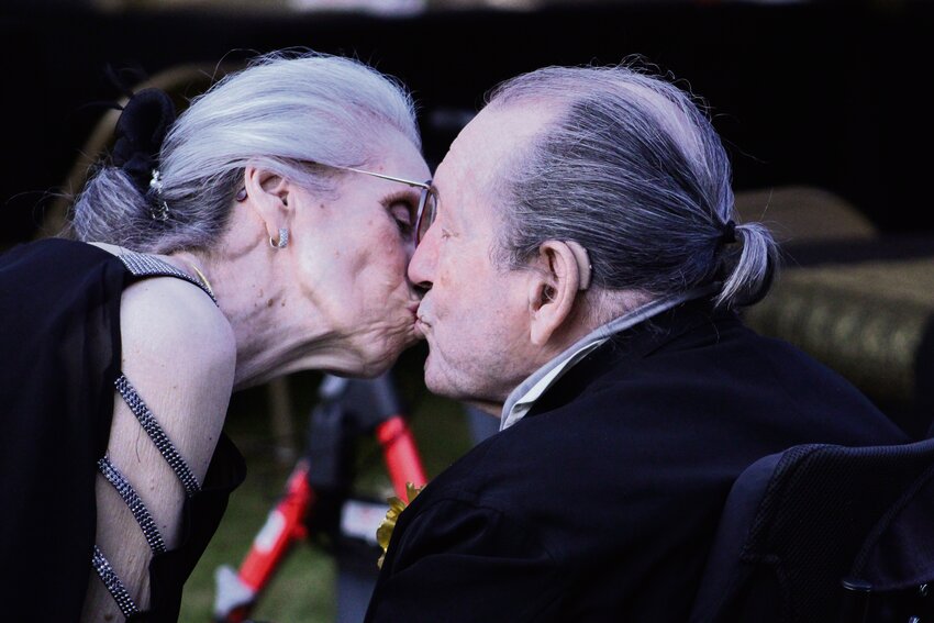 Myrna and Paul Morey share a kiss after they are named prom queen and king at the Prestige Senior Living Rosemont Prom on Aug. 10.