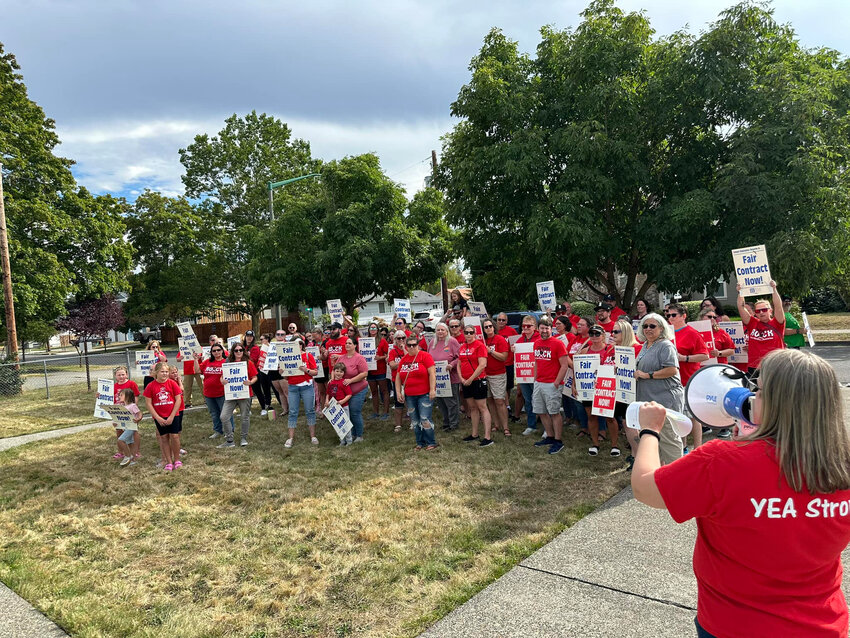 Members and supporters of the Yelm Education Association gather and holds signs reading 